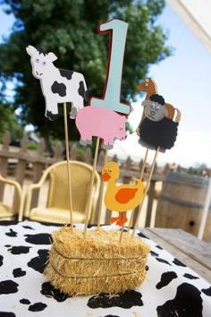 Adorable farm themed centerpieces for first birthday party with hay bale, animals and cow hide! #birthday #boy #girl #farm #animals