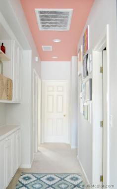 Want to keep a hallway white without it looking too sterile? Consider only painting the ceiling! Behr Youthful Coral ceiling with Behr Dolphin Fin walls