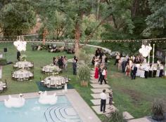 Inflatable swans floating in the pool and trees wrapped in strands of lights gave this classy affair a touch of whimsy. No worries about the swans attacking people either!: Floating Pool Swan by Gia Canali Photography. for party @ parents house  | followpics.co