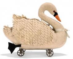 A STEIFF EARLY FELT SWAN ON WHEELS, (651-1 or 22R), white, black boot button eyes, red felt discs behind, orange beak and black feet, carded wings, blue ribbon, on wire frame with four cut steel six-spoked wheels, probably pre-button, circa 1900 --11½ in. (29cm.) long (slightly discoloured)