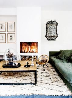 Shop the Room: Style by the Fire via @Domaine //  A forest green couch and unique curiosities make this cozy living room feel special. // Photo by Louise Desrosiers