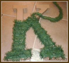 Hobby Lobby letter wrapped in Christmas tree garland and add lights...  I would like to do this this year!!