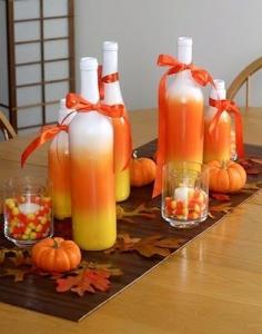 Have a lot of wine bottles laying around the house from your last party? Use white, orange and yellow spray paint to make your dinner table more festive! #winebottles #halloween