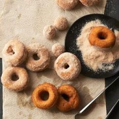 These delicious homemade doughnuts are rolled in a mixture of sugar, nutmeg, and cinnamon, complementing their pumpkin flavor.
