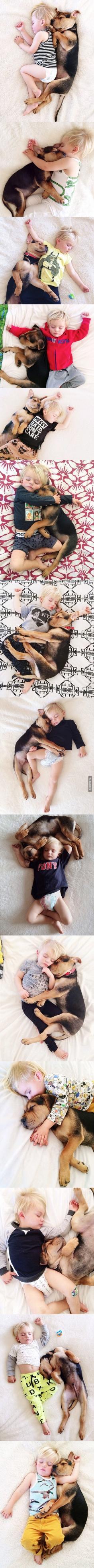 A toddler and his puppy continue napping together.... this is one of the cutest things ever