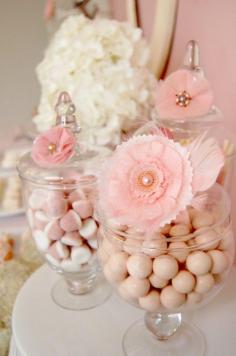 I have always loved the idea of doing a candy bar at parties (I actually did one for a baby shower I threw for my dear friend and it was a huge hit). I love how this person added those dainty little flowers to the jars...makes it super cute.