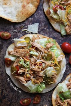 Loaded seasoned chicken tacos on a puffy fried tortilla. Recipe by @Rachel {Baked by Rachel}