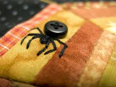 ~ BLACK BUTTON + EMBROIDERY = SPIDER for Halloween or Bug Quilt. To make a Black Widow Spider, sew on the button with red embroidery floss.