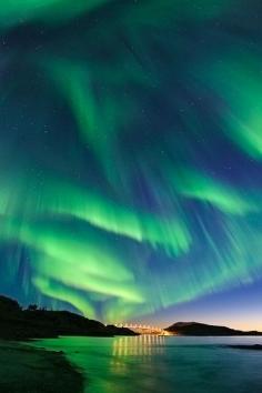 Aurora Borealis in Ersfjord, Norway.  During the Northern Hemisphere's autumn and spring, solar magnetic fields are oriented in just the right way to cause "rips" in Earth's magnetic field. The resulting increase in solar wind on Earth encourages auroral sky shows but can also damage satellite technology and electrical grids on the ground. (National Geographic)