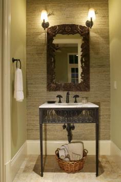 Bathroom 1 = 9-24-14 A small bathroom with character is what we all dream of. The green wall of this small space compliments the scone lighting and wicker accents! #smallbathroom #lotsofcharacter