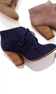 Soft suede lace up bootie with tassel detail on laces, rounded toe and a stacked heel.