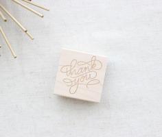 
                        
                            A little thank you can go quite far, especially inked on an envelope, kraft tag, cotton bag, or just about anything you desire. This custom rubber stamp is 2″x2″ and features custom lettering just for you. Please note that ink is not included but can be purchase at your local craft store!
                        
                    