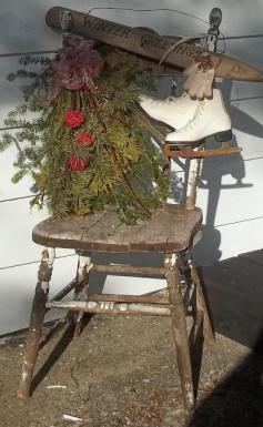 Pair of Ice Skates & Rustic Smell of Pine Hanging From a Vintage Wooden Chair in Winter