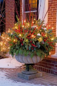 
                        
                            Add lights to decorative urns for added glow next to your front door. Holiday Outdoor Decorating Tips from Mariani Landscape - Traditional Home®
                        
                    
