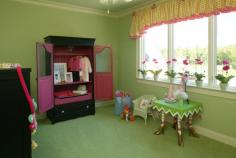 Very green kid's room with big play area, a small dresser, wall-to-wall carpet, crown molding and hot pink accents. Too much green?