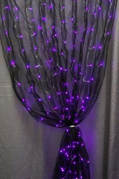 
                        
                            Black fabric sash and purple LED lights together makes for one really cool decoration.
                        
                    
