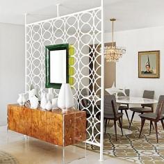 Jonathan Adler created this glam midcentury modern dining room. He shielded the quieter spot from the lively great room with an architectural screen affixed with two back-to-back Philippe Starck mirrors. Coastalliving.com