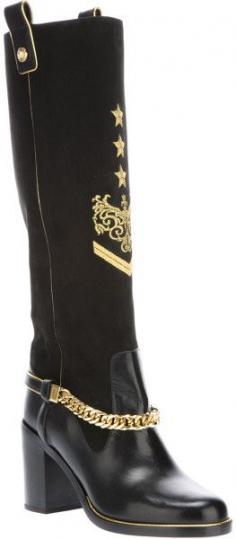 Black leather chain detail boots from versace featuring an almond toe, a chunky heel, a rubber sole, side pull on tabs, gold tone detailing and embroidery and contrast leathers.