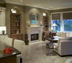 Transitional family room with custom bookshelves, granite counters for the kitchen, marble tile floors and white upholstered sofas. Very clean design.