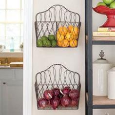 Hang magazine racks as holders for fruit/vegetable...towels...coffee/tea area...etc
