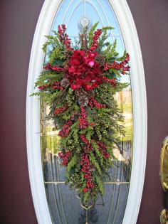 
                    
                        Christmas Teardrop Swag Door Decor.."Seasons Greetings". $80.00, via Etsy.
                    
                