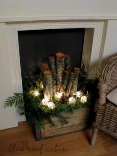 Wooden crate, greenery, logs, pine cones, and lights. For the front porch, I think.