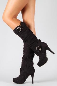 
                    
                        Black knee high boots with straps and heel
                    
                