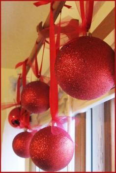 
                        
                            Styrofoam balls, sprayed with glue and then rolled in glitter. Much cheaper than huge ornaments and less breakable too
                        
                    