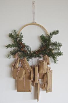 
                    
                        advent calendar -- brown paper packages tied with twine to a minimalist pine wreath
                    
                