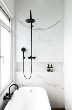 
                    
                        White Statuarietto marble bathroom wall + black shower. (by Dieter Vander Velpen Architect)
                    
                