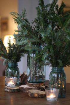 
                    
                        Christmas decor...pine branches in mason jars on wood coasters surrounded by tea lights. Cute idea for table centerpiece! Would work for winter wedding as well
                    
                