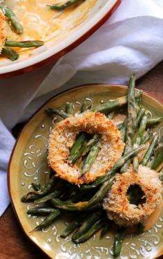 String bean casserole is lightened up with homemade spicy sriracha baked onion rings and a smoky creamy cream-less sauce.