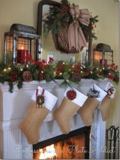 
                    
                        Christmas Mantel w awesome grapevine wreath with gorgeous burlap bow, Burlap Stockings, and lanterns!! Love it!
                    
                