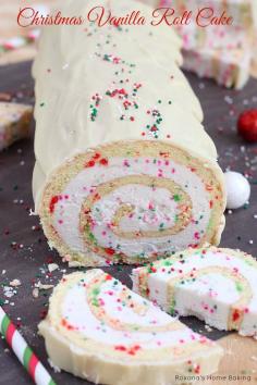 A simple vanilla roll cake with red and green dots and spirals of creamy buttercream