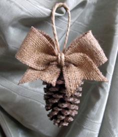 
                    
                        Pinecone Tassel / Ornament with burlap bow -- LOVE THIS! Easy DIY? Maybe hints of gold glitter on the pinecone? Scatter throughout the tree....
                    
                