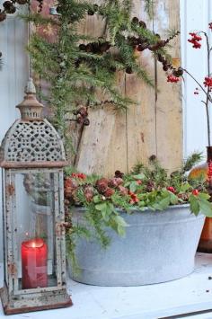 
                        
                            Simple greenery in a metal container with a lantern. VIBEKE DESIGN
                        
                    