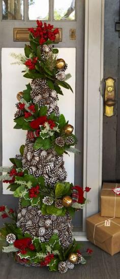 
                    
                        Easy to accomplish with a tomato cage.  Make each separately, greenery garland & pine cone garland, then wire to cage
                    
                