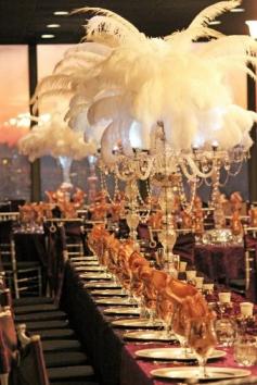 
                    
                        11-11-11 Ostrich Feather centerpieces atop crystal candelabra and reversible trumpet vases at City View by the James, designed and arranged by Love Is In The Air.
                    
                
