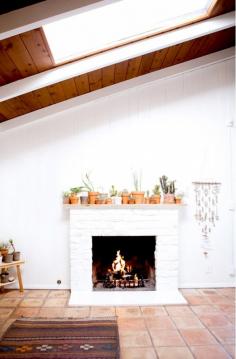 
                    
                        Laid back California hotel featuring a white brick fireplace and terra-cotta planters
                    
                