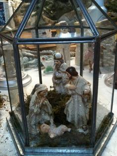 
                    
                        nativity scene displayed in a small terrarium or lantern.
                    
                