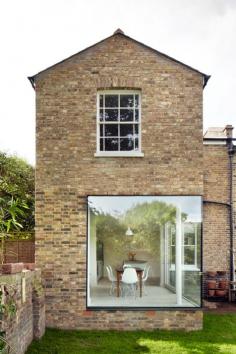 
                    
                        A large window wraps around one corner of this brickwork extension to a Victorian house in London by local office Cousins and Cousins
                    
                