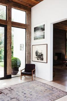 
                    
                        Reclaimed wood warms up the clean lines in Jenni Kayne's foyer.
                    
                