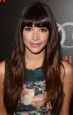 Hannah Simone bangs and long hair.