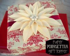 
                    
                        Easy Paper Poinsettia Gift Topper - gorgeous, but you could change the colors and make it look like another flower for different holidays or occassions.
                    
                