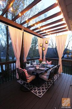 
                    
                        The outdoor curtains you see are a simple DIY by blogger Jen Stagg. We love how they add a bit of privacy and a lot of elegance to this backyard deck. The lights strung on the pergola complete the picture. Click through to learn more about Jen’s deck makeover.
                    
                