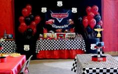 
                    
                        Red tablecloth under checkered tablecloth; red and black balloons in tires
                    
                