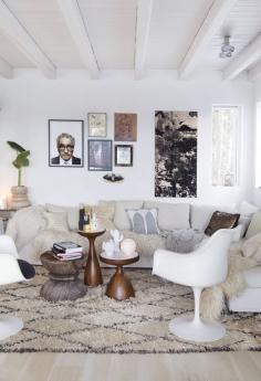 Although I'm a color and pattern girl, this white room with its beni ourain, mongolian wool throws and the different wood occasional tables sitting in for a coffee table have me wanting a white room.