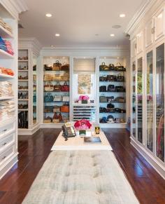 Yolanda Foster - Stunning walk-in closet features long tufted ottoman flanked by wall of small cabinets above built-in cabinets with glass doors as well as wall of shelves over pull-out lingerie drawers. Chic dressing room with floor to ceiling glass shelves flanking built-in chest beside built-in shelves for shoes