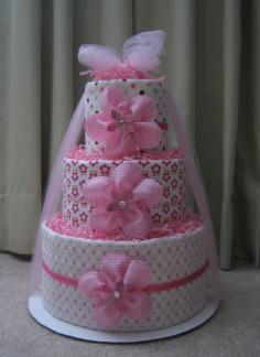 I like the use of the netting bunched up and around the cake to help hold it together and also give it a finished look. baby girl diaper cakes | ... Baby Girl Diaper Cake for Baby Shower Centerpiece and New Baby Gift Check out the website for more