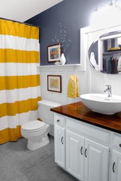 
                    
                        Even the smallest of rooms deserve a little ornamentation. Homeowners of this cottage bath made room for a vase and other display opportunities by installing a generous chair rail atop the wainscoting.
                    
                